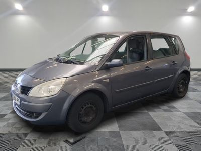 a picture of a small grey car parked in a garage