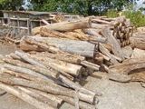 a man riding a skateboard on a ramp next to a pile of wood