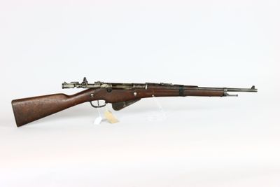 an old rifle with a wooden barrel on a white background