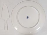 a white plate with a blue design on it next to a knife and fork