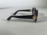 the sunglasses are black with gold accents and a purple lens