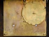 a gold clock with roman numerals on it