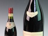 two bottles of wine sit next to each other on a table
