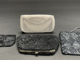 three pieces of purses are sitting on a table next to each other