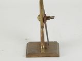a small brass sculpture of a man holding a knife