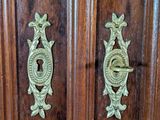 a wooden cabinet with a door handle and a keyhole