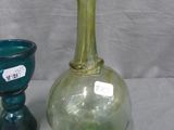 two glass vases sitting next to each other on a table