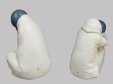 two salt and pepper shakers sitting next to each other