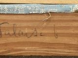 a piece of wood that has writing on it