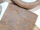 an old rusty piece of metal on a white surface