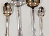 three silver spoons and two silver spoons on a white surface