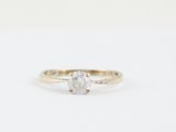 a close up of a diamond ring on a white background