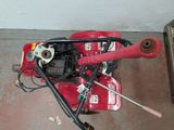 a small red machine that is sitting on the floor