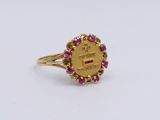 a close up of a gold ring with pink stones on it