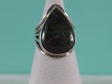 a close up of a ring with a tear shaped stone on it