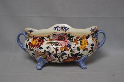 an image of a bowl with handles and flowers on it