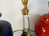 a blue vase and a red lamp on a table