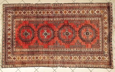 an old rug with a red and brown design on it