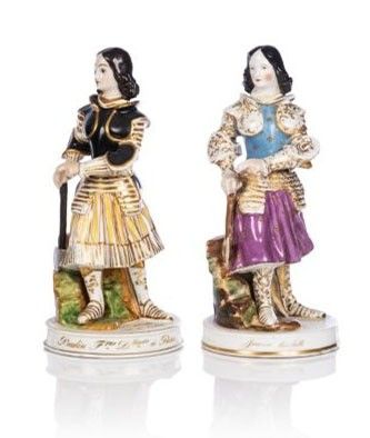 two figurines of women with a dog and a basket of flowers