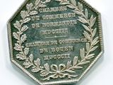 une image représentant une pièce d'argent ornée d'une couronne de feuilles