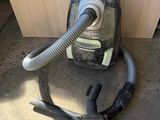 a vacuum that is sitting on the floor next to a piece of wood