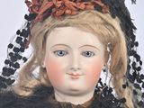 a close up of a doll with a veil on it ' s head