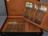 a wooden box with a bunch of silverware in it