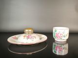 a small cup and saucer sitting on a table