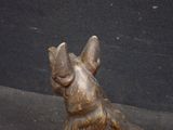 a statue of a dog that is sitting on the ground