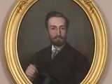 portrait of a man in a suit and tie holding a hat