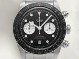the watch has a black dial on the face of the watch