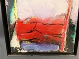 abstract painting of a red couch in a black frame on a wall