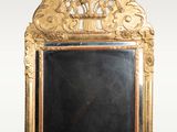 an ornate gold framed mirror with a blackboard in the middle