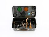 a black suitcase with tools in it on a white surface