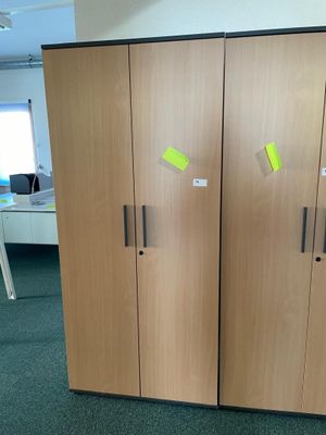 two wooden cupboards with post it notes on them