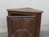 a small wooden cabinet with a door on top of it