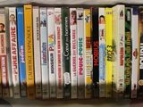 a lot of children ' s dvds on a shelf together