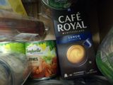 a can of coffee and a can of coffee on a shelf