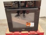 a microwave sitting on a pallet with a price tag