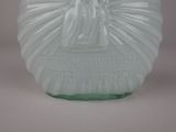 a green glass vase with a statue of a woman on it
