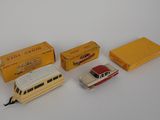 three toy cars and a box of boxes on a white surface