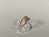 a close up of a diamond ring on a clear plate