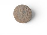 an old coin that is sitting on a white surface