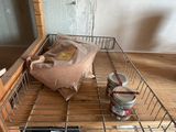 a metal shelf with a basket on top of it