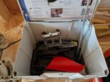 a white box with a red piece of equipment inside of it