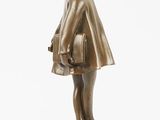 bronze figurine of a little girl with a basket of flowers