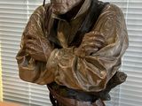 a statue of a man with a hat on a table