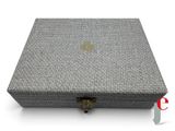 a grey box with a gold logo on the lid