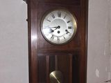 a clock hanging on the wall in the corner of a room