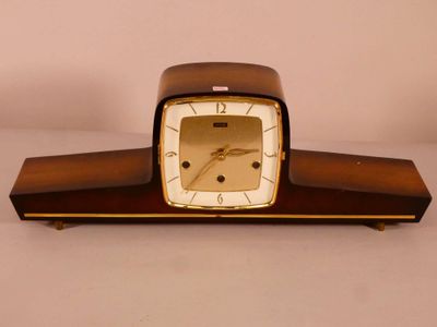 a wooden clock with a white face on a table